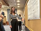 Clair presenting at the undergraduate research poster session, August 2023